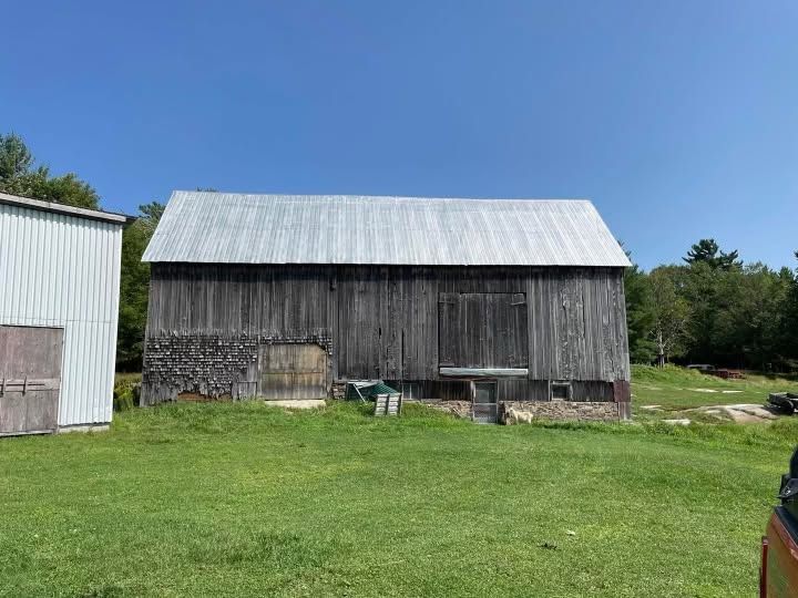 The same bank barn with its roof coated silver