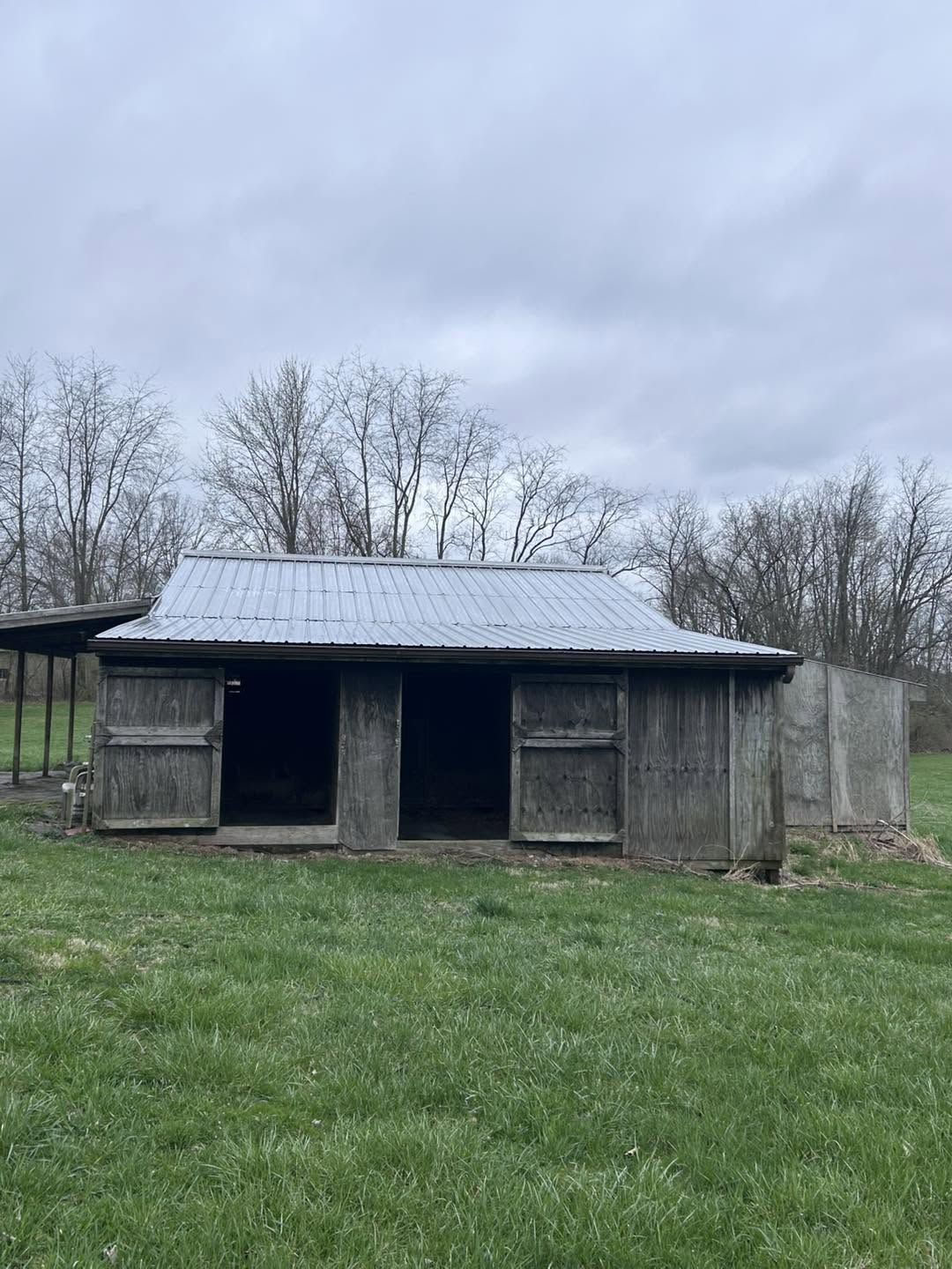 The same small barn with its roof coated silver